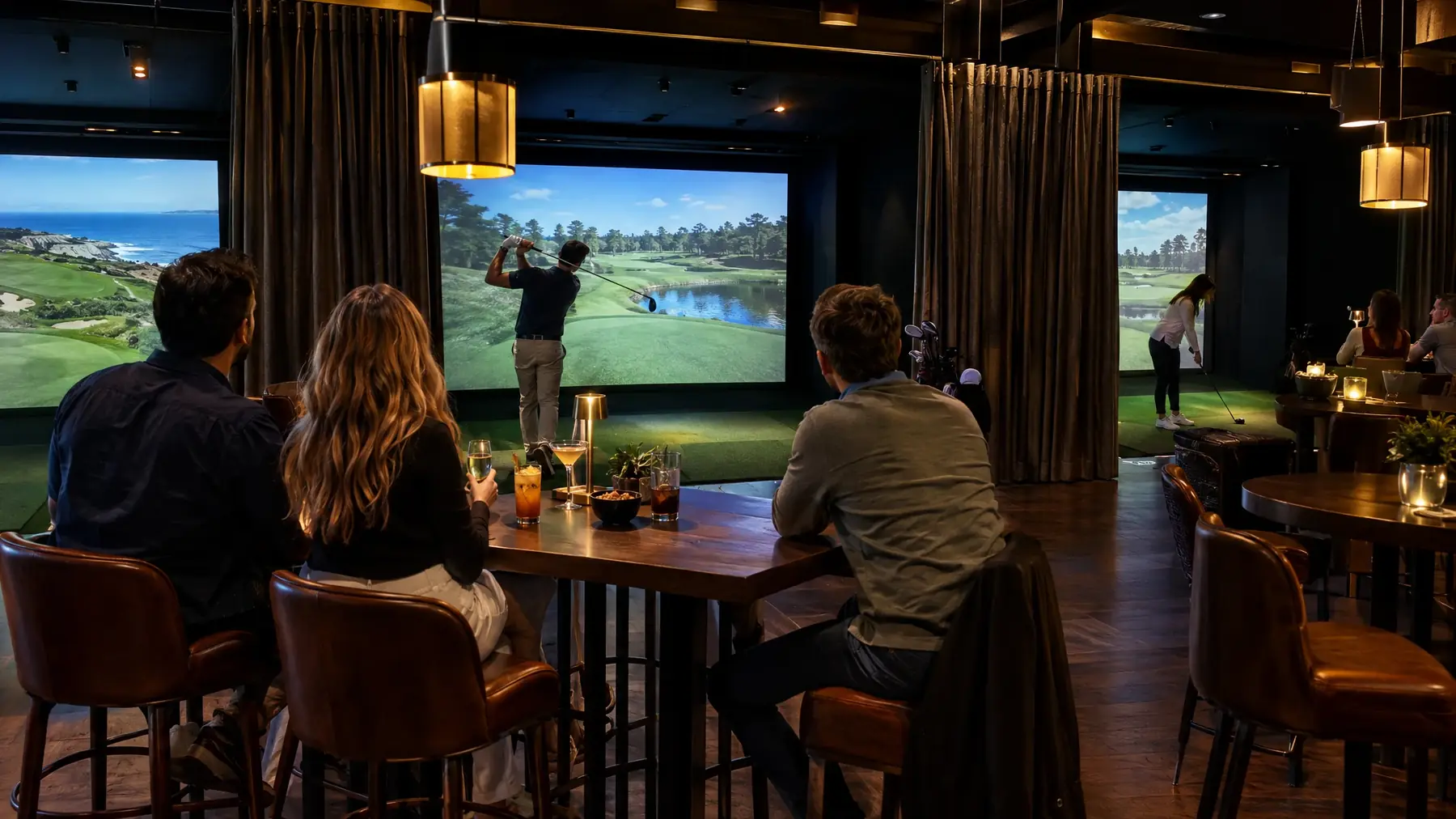 Commercial golf simulator lounge with several bays at a restaurant and bar