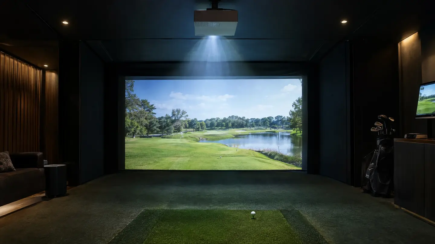 Ceiling projector above a golf simulator bay