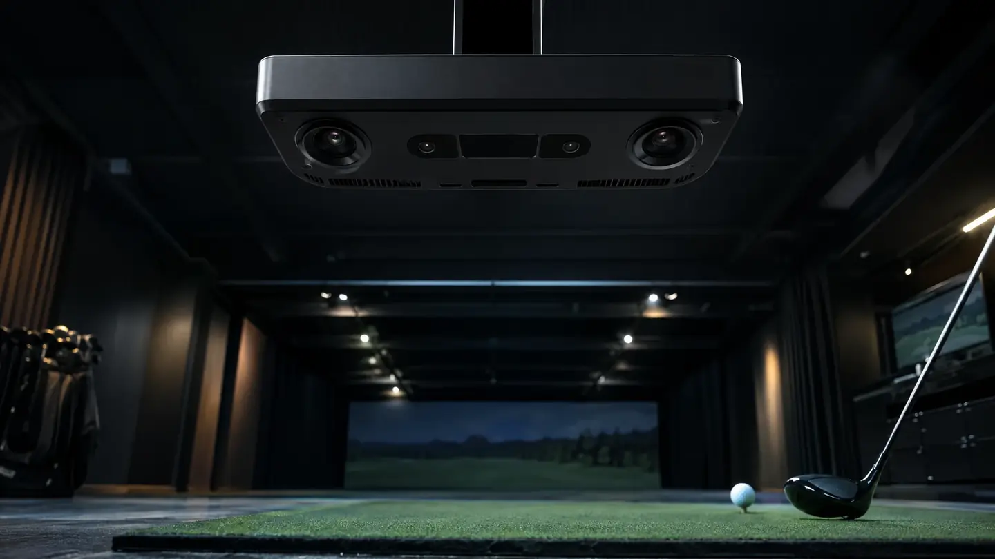 Ceiling-mounted overhead launch monitor above a hitting mat